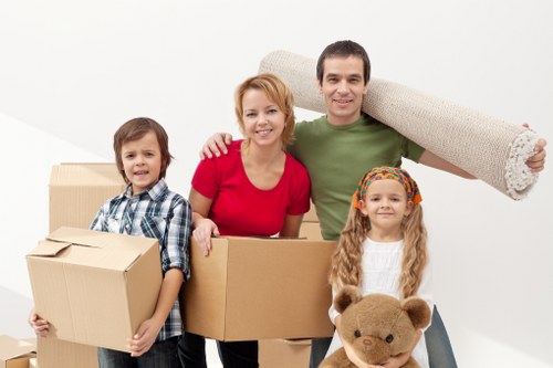 Movers protecting sofas and tables during a Belsizepark relocation