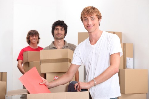 Specialist movers handling an upright piano in Belsize Park